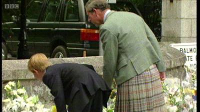 Prince Harry and and Prince Charles look at Diana tributes