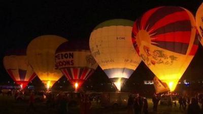 Balloons lit up at the Bristol International Balloon Fiesta