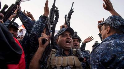 Soldiers and police officers in Mosul celebrate