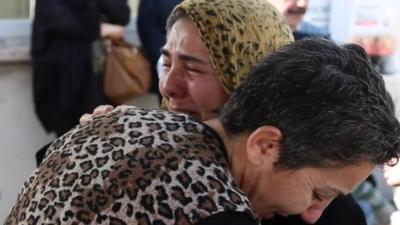 Relatives of victims console each other