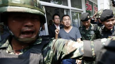 Politician Watana Muangsook arriving at a military base in Bangkok, Thailand