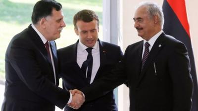 Prime Minister Fayez al-Sarraj and rival commander Khalifa Haftar shake hands