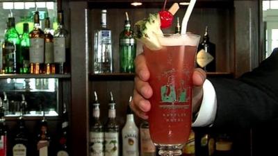 Singapore Sling cocktail is placed on the bar of the Raffles Hotel