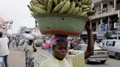 Woman carrying bananas on her head