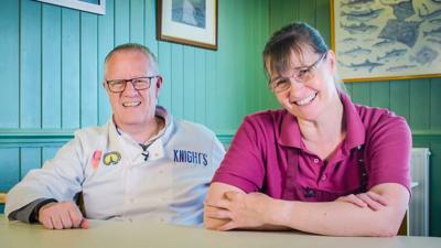 A couple from Glastonbury sat at a table.