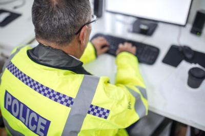 Policeman at a computer