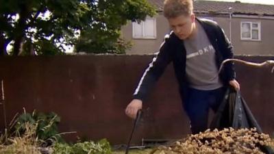 Boy clearing up rubbish