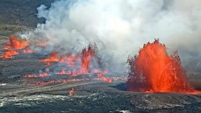 Bright orange lava fountains on volcano's crater