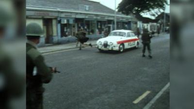 Police car in a scene from Scotch on the Rocks