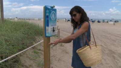 A woman applies sun cream