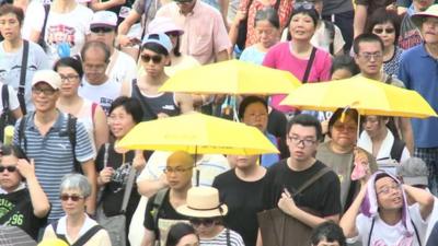 Protesters with yellow umbrellas