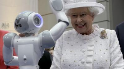 Robot waves at Queen