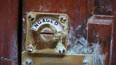 Engaged sign on public toilet door