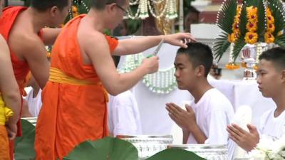 One of the Thai cave boys gets a haircut from a Buddhist monk