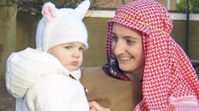 Woman dressed as shepherd and child dressed as sheep