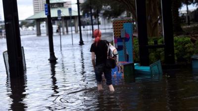 Woman walking in Florida floodwaters