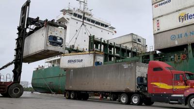 A container ship is loaded with shipping containers at Port Everglades, in Fort Lauderdale, Florida