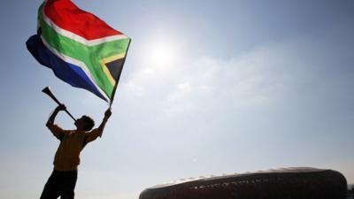 Man waving South African flag