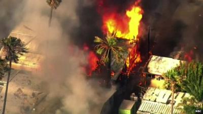 Aerial shot of mobile homes burning in a mobile home park in Sacramento, California