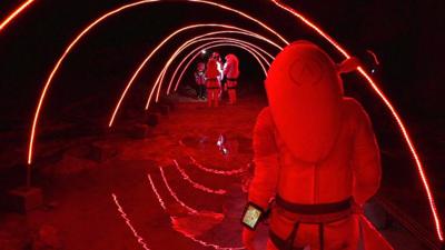 People in "space suits" walking down a tunnel