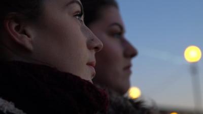 Two sisters looking out