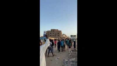 Soldiers march down a street