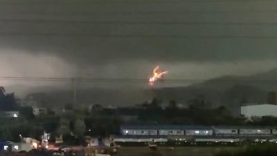 Fire erupts as tornado hits power lines