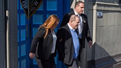 Harvey Weinstein is led out of the New York Police Department