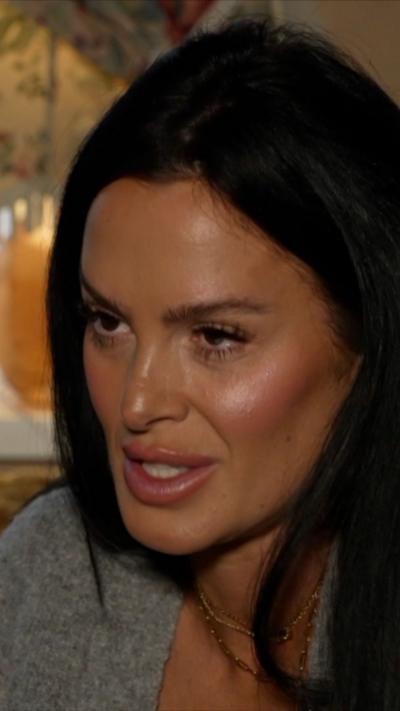 Close up woman with long dark hair in a room 