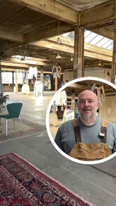 Industrial warehouse-style space with exposed beams and a circular inset showing a person in brown overalls.