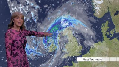 BBC Weather presenter Louise Lear standing in front of a weather chart depicting heavy rain