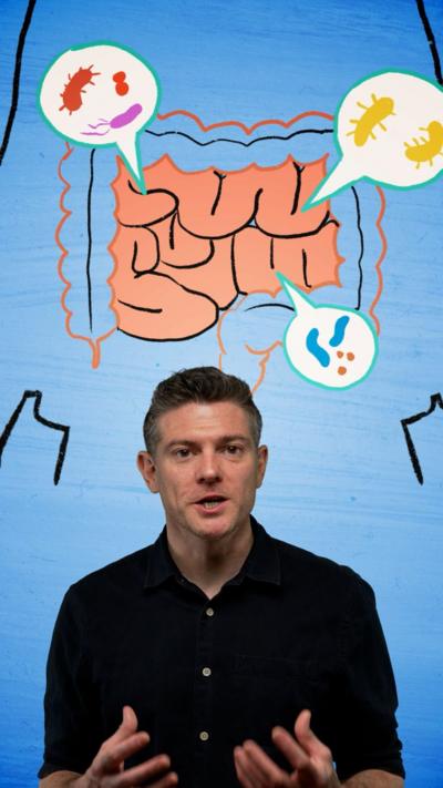 Man looking at the camera with an illustration of a stomach behind him