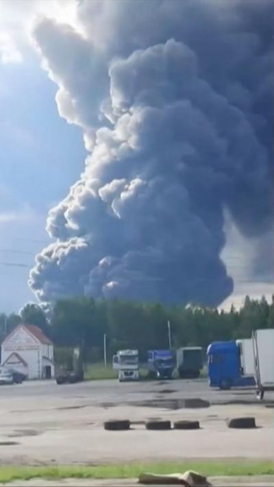 Huge plume of dark smoke rises from the horizon