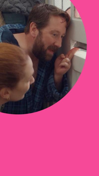 A man and woman talk through the letterbox