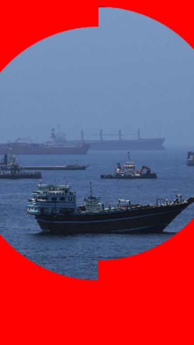 Ships in a body of water about to enter the Strait of Hormuz.