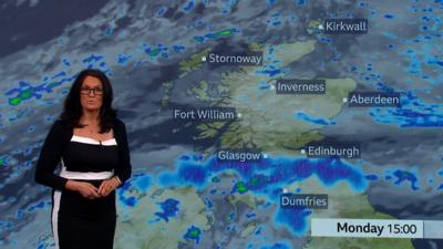 Judith Ralston presents the weather showing heavy rain forecast over the central belt. She wears a black and white dress.