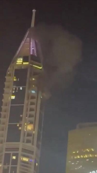 Dubai Marina tower with smoke surrounding the top