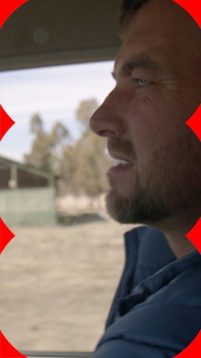 Side view of a man driving a car