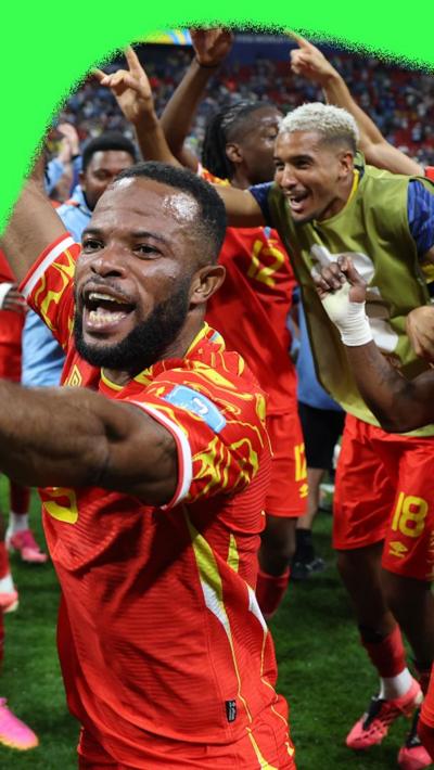 DR Congo players celebrating progressing at the World Cup. They are wearing red DR Congo away kits.