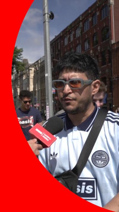 A fan from Argetina speaks into a microphone on a street in Cardiff