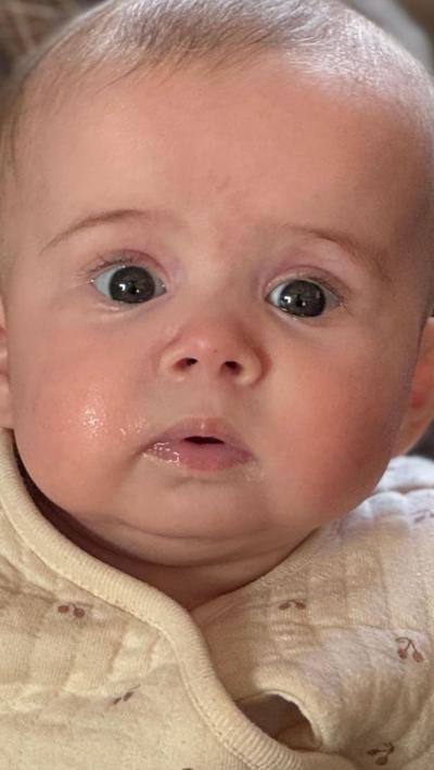A baby girl wearing a cream jacket