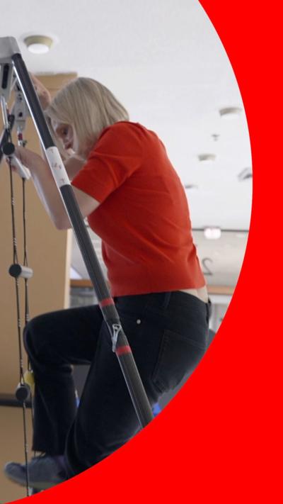 Rebecca Morelle climbing up a ladder