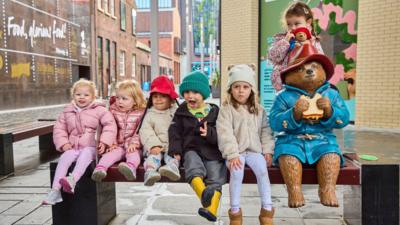 Paddington statue and children in Liverpool.