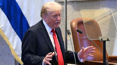 US president Donald Trump speaking at a podium in the Knesset