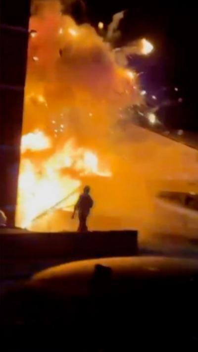 Large explosion, a person is in the foreground