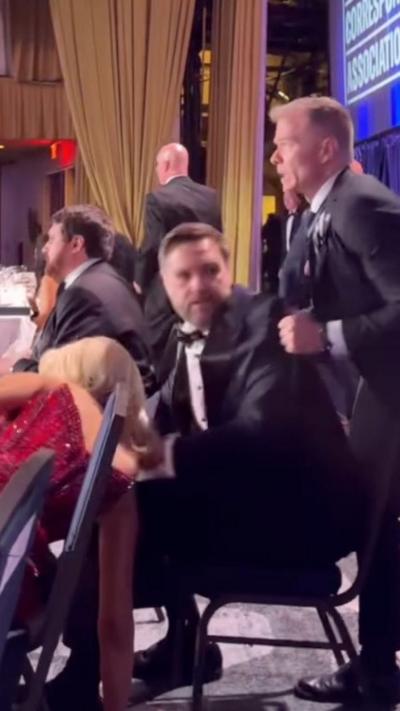 JD Vance being pulled out of his chair at White House Correspondents' dinner