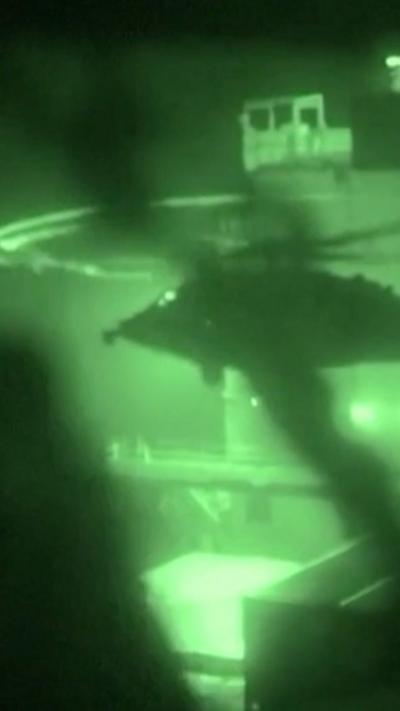 A helicopter is seen in front of the ship