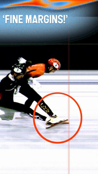 Two speed skaters near the finish line with their skates crossing 