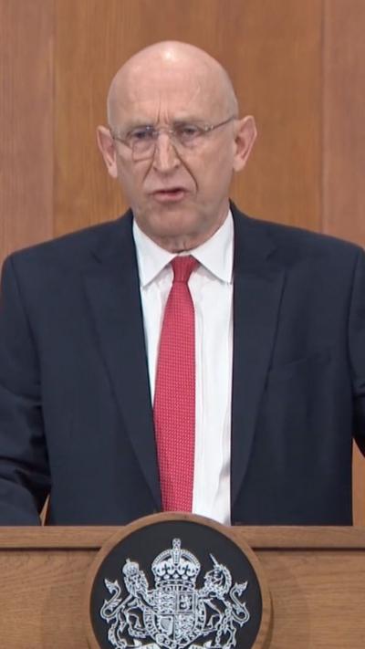 Healy speaking during press conference