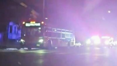 Bus with screen reading "911 CALL POLICE" chased by police cars